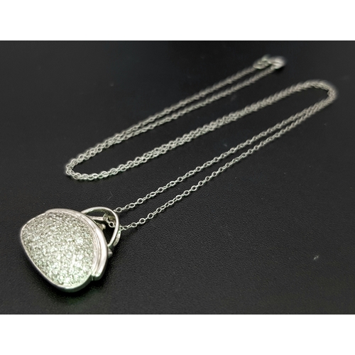 1070 - A 14K White Gold and Diamond Handbag Pendant on a 9K White Gold Chain. 18mm and 44cm. 3.4g. Ref: 6.3