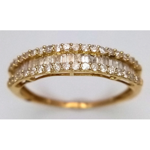 1083 - An 18K Yellow Gold and Diamond Ring. Centre baguette cut row with round cut rows either side. Size P... 