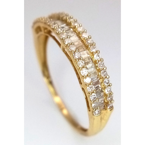 1083 - An 18K Yellow Gold and Diamond Ring. Centre baguette cut row with round cut rows either side. Size P... 