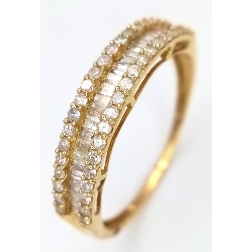 1083 - An 18K Yellow Gold and Diamond Ring. Centre baguette cut row with round cut rows either side. Size P... 