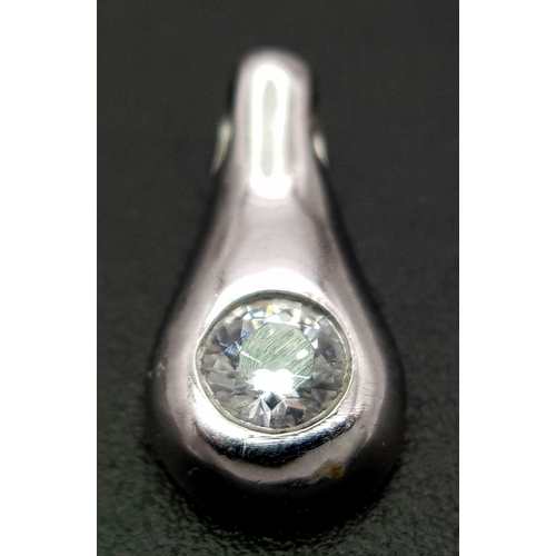 1111 - A 9K WHITE GOLD STONE SET PENDANT .     1.2gms