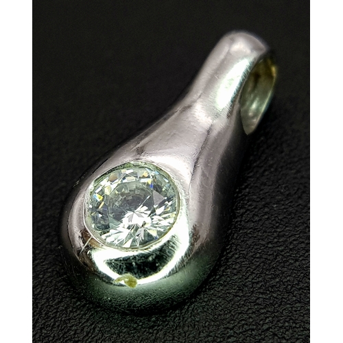 1111 - A 9K WHITE GOLD STONE SET PENDANT .     1.2gms