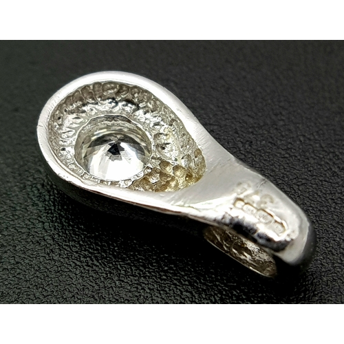 1111 - A 9K WHITE GOLD STONE SET PENDANT .     1.2gms