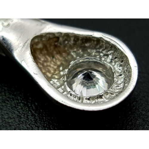 1111 - A 9K WHITE GOLD STONE SET PENDANT .     1.2gms