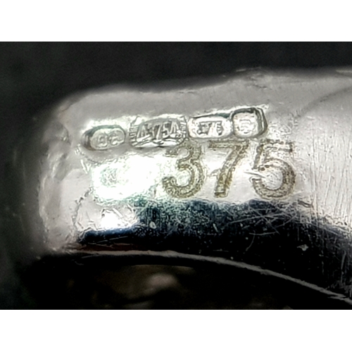 1111 - A 9K WHITE GOLD STONE SET PENDANT .     1.2gms