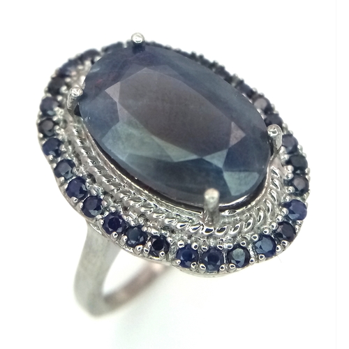 1105 - A 5ct Blue Sapphire Ring with a halo of Blue Sapphire Accents. Set in 925 Silver. Size M 1/2. With c... 