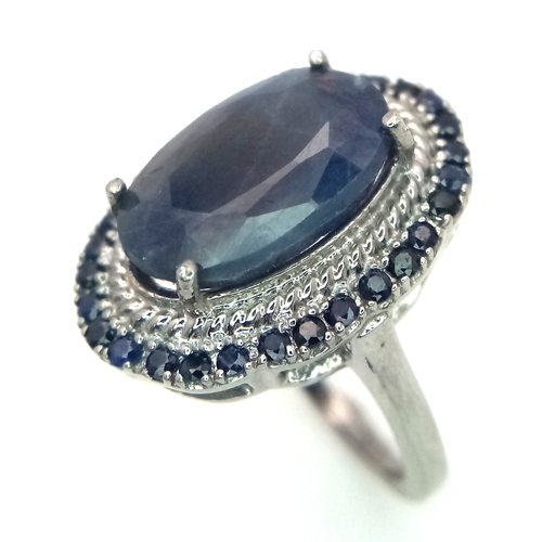 1105 - A 5ct Blue Sapphire Ring with a halo of Blue Sapphire Accents. Set in 925 Silver. Size M 1/2. With c... 
