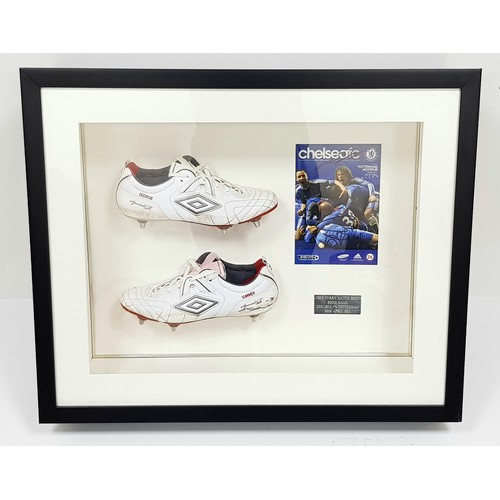 A Pair of Chelsea Legend, John Terry's 500th game SIGNED Match Worn Boots in a Framed Display Case! On the 30th of April 2011 Chelsea beat their North London rivals, Spurs 2-1. The signed Umbro boots and matchday programme were given to the Capital Radio winners of the Help a London Child Charity Bidding Auction. The prize was a family of four to be treated as 'Chairman for the Day' at Stamford Bridge. Luckily, they picked John Terry's 500th Chelsea game! Their VIP package included sporting memorabilia for the day, but this was the stand-out piece. After the match JT signed and graciously gave these boots (plus other items to come at later auctions!) to the competition winners - Unique, sporting memorabilia at its best. In frame - 61 x 74 x 16cm.