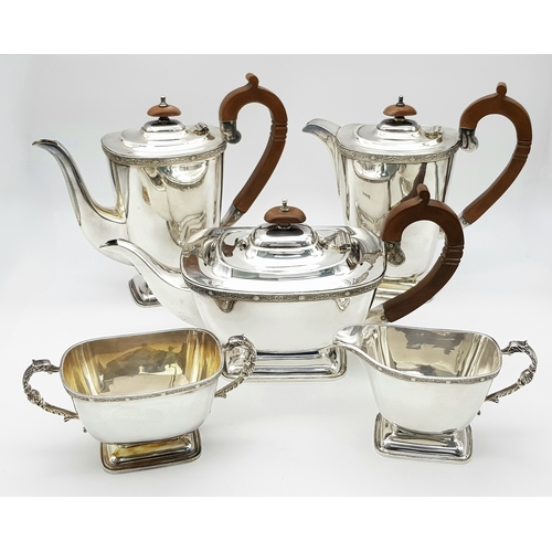 A Vintage Sterling Silver Art Deco Style Tea and Coffee Set; Includes: Teapot - 30 x 14cm, coffee pot 24 x 22cm, hot water pot 22 x 22cm, sugar pot 17 x 9cm and creamer jug - 15 x 9cm. Wooden handles. Hallmarks for Sheffield 1961. 2426g total weight.