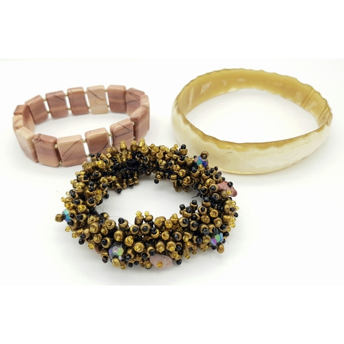 1616 - 3x vintage Fashion Bracelets. 
Including a horn-style bangle, a multi-strand beaded bracelet with go... 