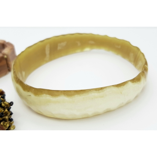1616 - 3x vintage Fashion Bracelets. 
Including a horn-style bangle, a multi-strand beaded bracelet with go... 