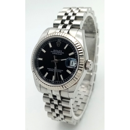 An Automatic Rolex Datejust Ladies Watch. Model 178274. Stainless steel bracelet and case - 33mm. Beautiful black dial. In very good condition and working order. Comes with box (and outer box) plus an array of papers and reports.