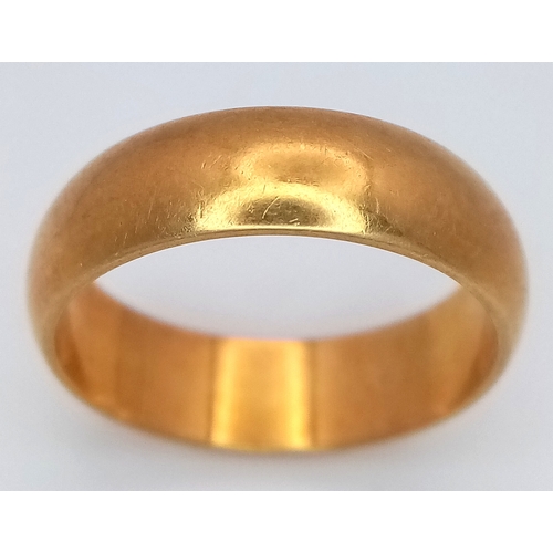 8 - An 18K Yellow Gold Band Ring. UK hallmarks. 6mm width. Size O. 6.4g.