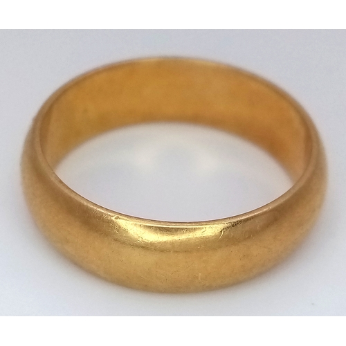 8 - An 18K Yellow Gold Band Ring. UK hallmarks. 6mm width. Size O. 6.4g.