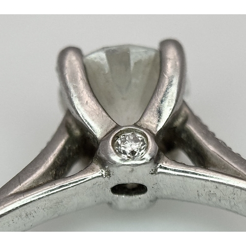 12 - A 950 Platinum and Diamond Ring. A 0.45ct round brilliant cut diamond with diamond accents on should... 