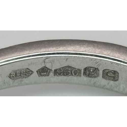 12 - A 950 Platinum and Diamond Ring. A 0.45ct round brilliant cut diamond with diamond accents on should... 
