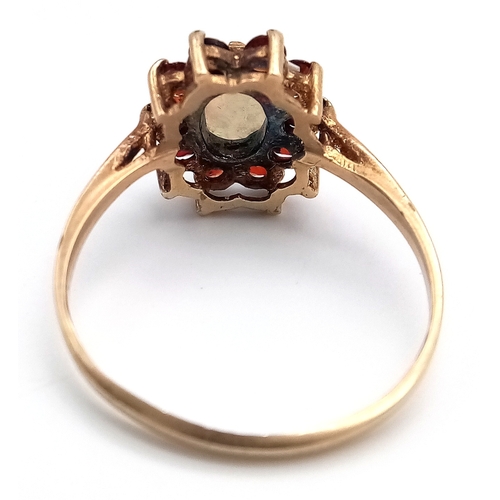 21 - Vintage 9 CARAT GOLD, OPAL and GARNET RING. Full UK hallmark. 2.0 Grams. Size N 1/2.