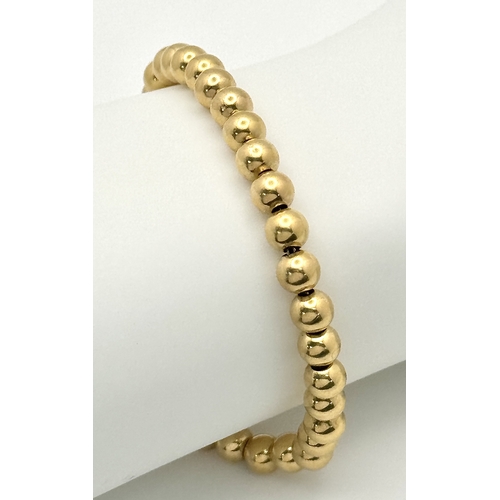 22 - An 18K Yellow Gold Bauble Link Chain Bracelet. 18cm. 6.35g.