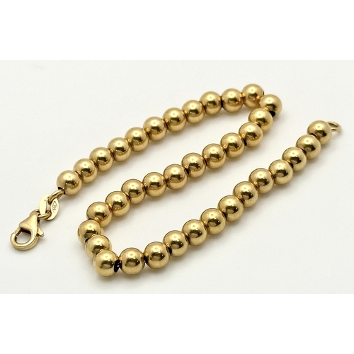 22 - An 18K Yellow Gold Bauble Link Chain Bracelet. 18cm. 6.35g.