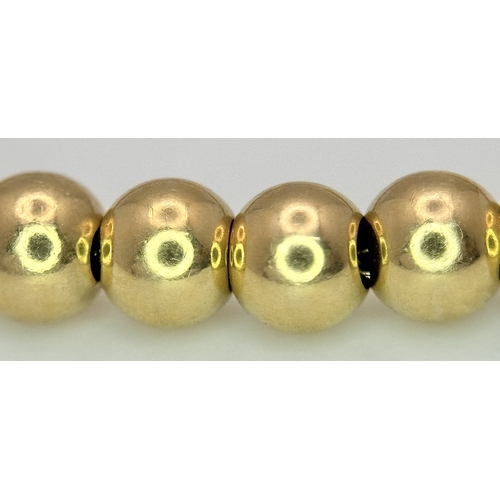 22 - An 18K Yellow Gold Bauble Link Chain Bracelet. 18cm. 6.35g.