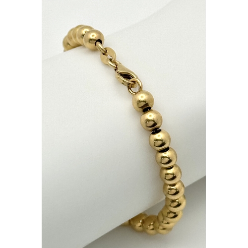 22 - An 18K Yellow Gold Bauble Link Chain Bracelet. 18cm. 6.35g.