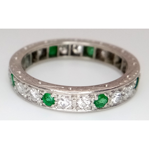 31 - AN 18K WHITE GOLD, DIAMOND AND EMERALD SET, FULL ETERNITY RING. 0.50 TCW, 4.7G, SIZE O. SC 4049