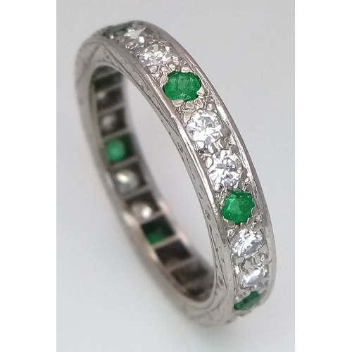 31 - AN 18K WHITE GOLD, DIAMOND AND EMERALD SET, FULL ETERNITY RING. 0.50 TCW, 4.7G, SIZE O. SC 4049