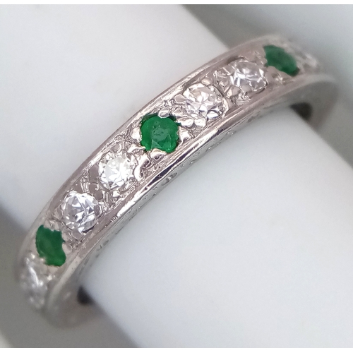 31 - AN 18K WHITE GOLD, DIAMOND AND EMERALD SET, FULL ETERNITY RING. 0.50 TCW, 4.7G, SIZE O. SC 4049