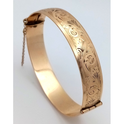 43 - A Vintage 9K Gold (Metal Core) Bangle. 13mm width. Clip open design. Safety chain. 27.5g total weigh... 