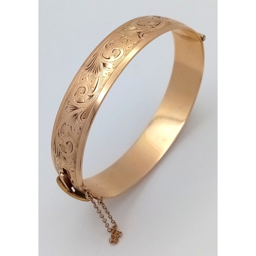 43 - A Vintage 9K Gold (Metal Core) Bangle. 13mm width. Clip open design. Safety chain. 27.5g total weigh... 