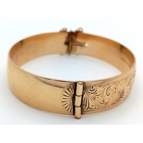 43 - A Vintage 9K Gold (Metal Core) Bangle. 13mm width. Clip open design. Safety chain. 27.5g total weigh... 