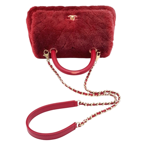 54 - A Chanel Burgundy Shearling Coco Top Handle Bag. Burgundy textile exterior with gold tone hardware, ... 