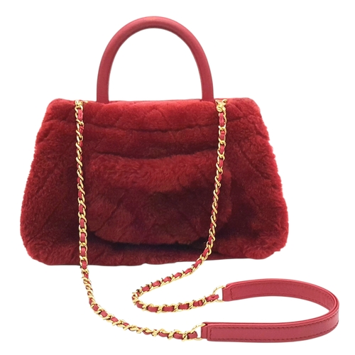 54 - A Chanel Burgundy Shearling Coco Top Handle Bag. Burgundy textile exterior with gold tone hardware, ... 