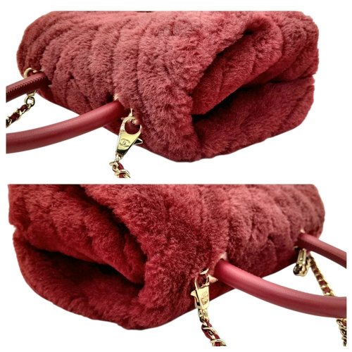 54 - A Chanel Burgundy Shearling Coco Top Handle Bag. Burgundy textile exterior with gold tone hardware, ... 
