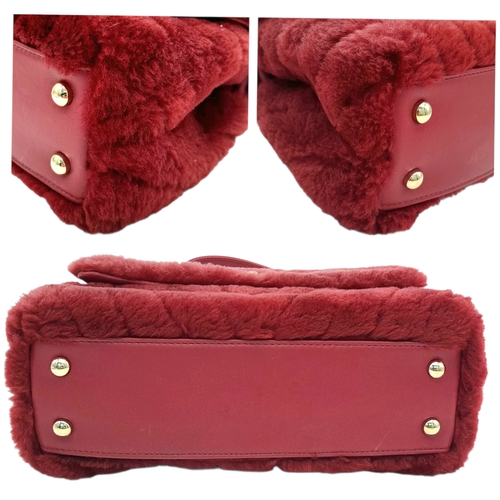 54 - A Chanel Burgundy Shearling Coco Top Handle Bag. Burgundy textile exterior with gold tone hardware, ... 