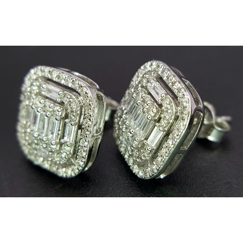93 - A Pair of 9K White Gold Diamond Dress Earrings. c2ctw of round and baguette cut diamonds. Square stu... 