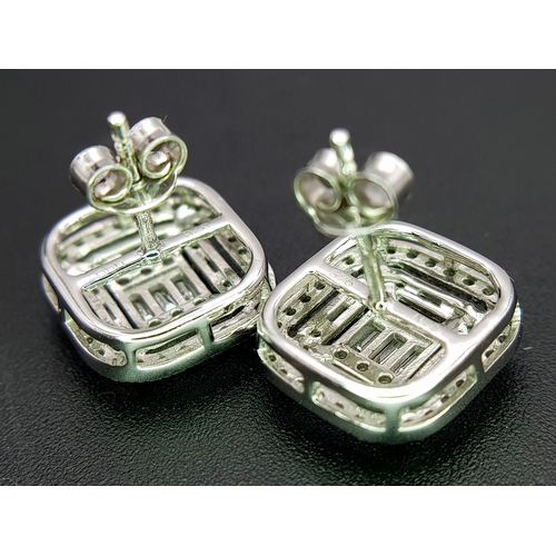 93 - A Pair of 9K White Gold Diamond Dress Earrings. c2ctw of round and baguette cut diamonds. Square stu... 