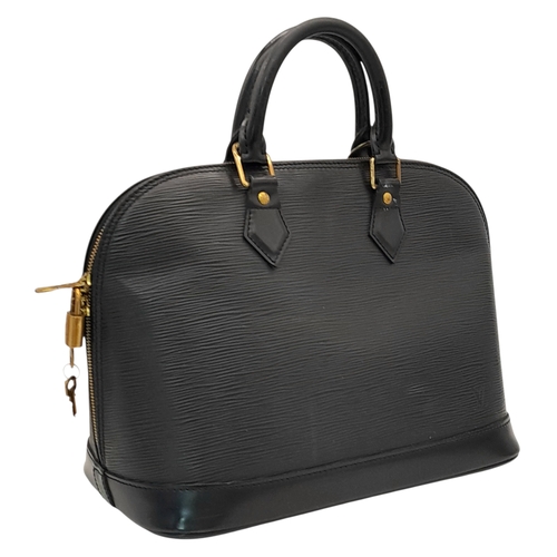 194 - A Louis Vuitton Black Epi Leather Alma PM Bag. Black Epi leather exterior with gold-tone hardware, d... 