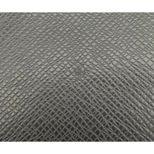 509 - A Louis Vuitton Taiga Baikal Leather Clutch Bag. Black leather exterior with silver-tone hardware, a... 