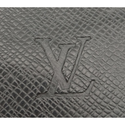 509 - A Louis Vuitton Taiga Baikal Leather Clutch Bag. Black leather exterior with silver-tone hardware, a... 