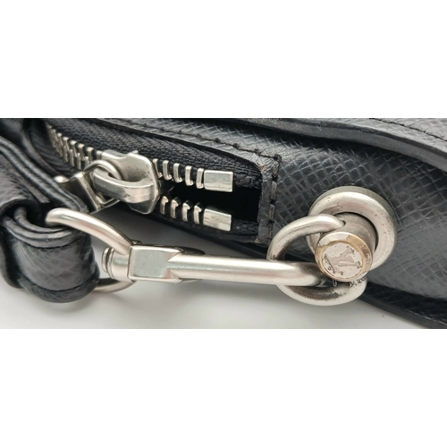509 - A Louis Vuitton Taiga Baikal Leather Clutch Bag. Black leather exterior with silver-tone hardware, a... 