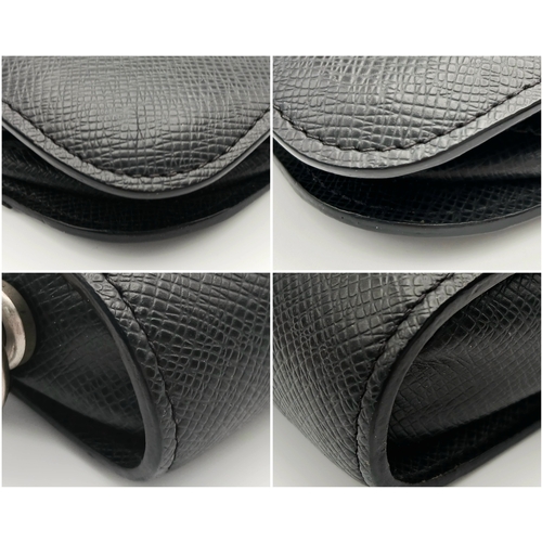 509 - A Louis Vuitton Taiga Baikal Leather Clutch Bag. Black leather exterior with silver-tone hardware, a... 