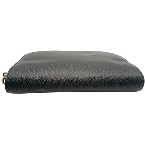509 - A Louis Vuitton Taiga Baikal Leather Clutch Bag. Black leather exterior with silver-tone hardware, a... 
