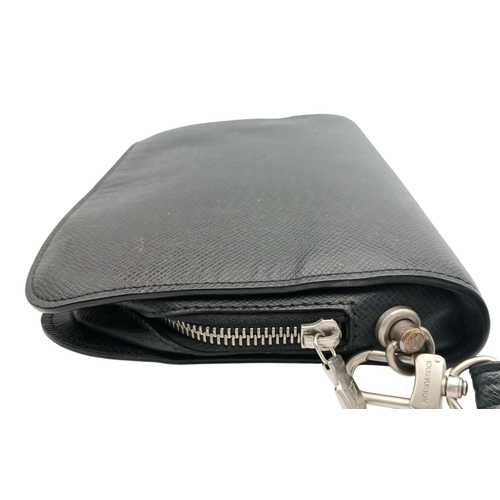 509 - A Louis Vuitton Taiga Baikal Leather Clutch Bag. Black leather exterior with silver-tone hardware, a... 