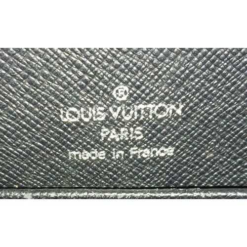 509 - A Louis Vuitton Taiga Baikal Leather Clutch Bag. Black leather exterior with silver-tone hardware, a... 