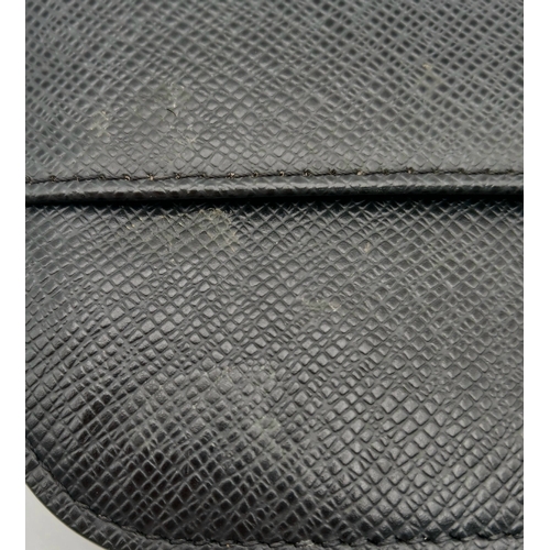 509 - A Louis Vuitton Taiga Baikal Leather Clutch Bag. Black leather exterior with silver-tone hardware, a... 
