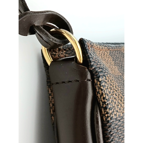 516 - A Louis Vuitton Brown Damier Ebene Pochette Accessoires. Brown Damier Ebene coated canvas exterior w... 