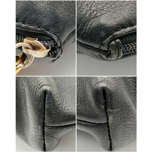530 - A Christian Dior Black Leather Cosmetic Pouch. Black leather exterior with gold-tone hardware and to... 