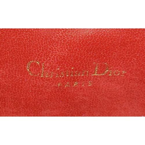530 - A Christian Dior Black Leather Cosmetic Pouch. Black leather exterior with gold-tone hardware and to... 