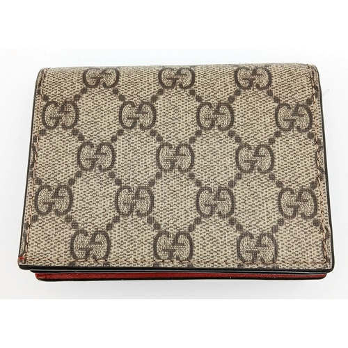 549 - A Gucci GG Supreme Cherry Card Holder Wallet. Ebony GG Supreme canvas exterior with gold-tone hardwa... 